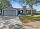 House with a two-car garage and manicured lawn at 1143 Waterview Pt, Lakeland, FL 33801