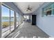Spacious Florida room with lake view and ceiling fan at 1143 Waterview Pt, Lakeland, FL 33801
