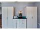 White kitchen cabinets and granite countertop with built-in coffee station at 1143 Waterview Pt, Lakeland, FL 33801