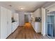 Modern kitchen with white cabinets, granite countertops, and stainless steel appliances at 1143 Waterview Pt, Lakeland, FL 33801
