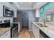 Modern kitchen with granite countertops and stainless steel appliances at 1143 Waterview Pt, Lakeland, FL 33801