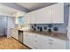 Modern kitchen with white cabinets, granite countertops and stainless steel appliances at 1143 Waterview Pt, Lakeland, FL 33801