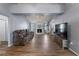 Spacious living room featuring hardwood floors, a fireplace, and large TV at 1143 Waterview Pt, Lakeland, FL 33801