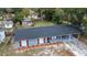 Aerial view of a newly renovated gray brick house with a carport at 115 7Th Jpv St, Winter Haven, FL 33880