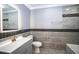 Updated bathroom with gray tile and vanity at 115 7Th Jpv St, Winter Haven, FL 33880