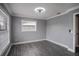 Empty bedroom with hardwood floors and neutral gray walls at 115 7Th Jpv St, Winter Haven, FL 33880
