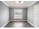 Simple bedroom with wood-look floors and window at 115 7Th Jpv St, Winter Haven, FL 33880
