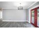 Bright dining room with gray walls, hardwood floors, and french doors at 115 7Th Jpv St, Winter Haven, FL 33880