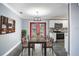 Dining room with red doors leading to backyard and rustic dining table at 115 7Th Jpv St, Winter Haven, FL 33880
