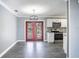 Dining room with red doors and gray walls, hardwood floors at 115 7Th Jpv St, Winter Haven, FL 33880