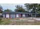 Newly renovated house featuring gray brick, red shutters, and a carport at 115 7Th Jpv St, Winter Haven, FL 33880