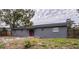 Gray house with red door, backyard view at 115 7Th Jpv St, Winter Haven, FL 33880