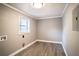 Simple laundry room with wood-look floors at 115 7Th Jpv St, Winter Haven, FL 33880