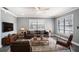 Living room with a large TV, comfortable seating, and hardwood floors at 115 7Th Jpv St, Winter Haven, FL 33880
