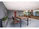 Covered patio with dining set, great for outdoor entertaining at 115 7Th Jpv St, Winter Haven, FL 33880