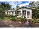 Front view of a white house with overgrown landscaping at 1329 Mount Pisgah Rd, Fort Meade, FL 33841