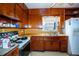 Small kitchen with wood cabinets and appliances at 1329 Mount Pisgah Rd, Fort Meade, FL 33841