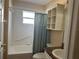 Clean bathroom with shower/tub combo, vanity, and built-in shelving at 137 Harbor Way, Auburndale, FL 33823