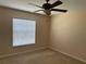 Well-lit bedroom featuring a ceiling fan and large window at 137 Harbor Way, Auburndale, FL 33823