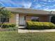 Front entrance of a tan house with landscaping at 137 Harbor Way, Auburndale, FL 33823