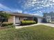 Tan house with white garage door and landscaping at 137 Harbor Way, Auburndale, FL 33823
