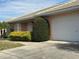 White garage and part of tan house exterior at 137 Harbor Way, Auburndale, FL 33823