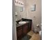 Bathroom with vanity, dark brown cabinets, and a large mirror at 1371 Tuscan Ter # 3403, Davenport, FL 33896