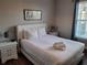 Bedroom featuring a white bed, two nightstands and plenty of natural light at 1371 Tuscan Ter # 3403, Davenport, FL 33896