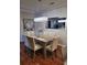 Dining room with a rustic wood table and six beige chairs at 1371 Tuscan Ter # 3403, Davenport, FL 33896