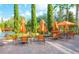 Resort-style pool area with tables, chairs, and umbrellas at 1371 Tuscan Ter # 3403, Davenport, FL 33896