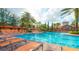 Large community pool with plenty of lounge chairs at 1371 Tuscan Ter # 3403, Davenport, FL 33896
