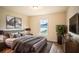 Main bedroom with a king-size bed, large window, and modern dresser at 1548 Normandy Heights Blvd, Winter Haven, FL 33880
