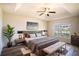 Main bedroom with a king bed, bench at foot, and plant at 1548 Normandy Heights Blvd, Winter Haven, FL 33880
