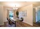 Contemporary dining room with metal table and four brown leather chairs at 1548 Normandy Heights Blvd, Winter Haven, FL 33880