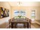 Bright dining room features a rustic wood table with leather chairs and large window at 1548 Normandy Heights Blvd, Winter Haven, FL 33880