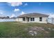 House back view, featuring a covered patio and a large yard at 1548 Normandy Heights Blvd, Winter Haven, FL 33880