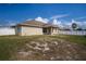 House back view with covered patio and fenced-in backyard at 1548 Normandy Heights Blvd, Winter Haven, FL 33880