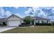 House front view, featuring a two-car garage and manicured lawn at 1548 Normandy Heights Blvd, Winter Haven, FL 33880