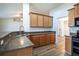 Kitchen with wood cabinets, stainless steel appliances, and island at 1548 Normandy Heights Blvd, Winter Haven, FL 33880