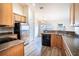 Open kitchen with island, stainless steel appliances, and wood cabinets at 1548 Normandy Heights Blvd, Winter Haven, FL 33880