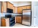 Corner kitchen with stainless steel appliances and wood cabinets at 1548 Normandy Heights Blvd, Winter Haven, FL 33880