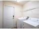 Laundry room with washer, dryer, and ample storage at 1548 Normandy Heights Blvd, Winter Haven, FL 33880