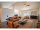 Open living room with leather sofas, coffee table, and access to dining area at 1548 Normandy Heights Blvd, Winter Haven, FL 33880