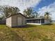 Large backyard with shed and screened patio at 162 N 2Nd St, Eagle Lake, FL 33839