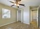 Bedroom with tile floors, ceiling fan, and closet at 162 N 2Nd St, Eagle Lake, FL 33839