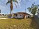 One story house with a large front yard and a chain link fence at 162 N 2Nd St, Eagle Lake, FL 33839