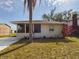 Cute one-story house with a screened porch and a palm tree in the front yard at 162 N 2Nd St, Eagle Lake, FL 33839