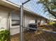 Side of house showing AC unit and chain link fence at 162 N 2Nd St, Eagle Lake, FL 33839