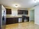 Kitchen with dark cabinets, granite counters, and stainless steel appliances at 162 N 2Nd St, Eagle Lake, FL 33839