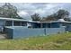 Back of house showing screened patio and block wall at 1705 Fredricksburg Ave, Lakeland, FL 33803